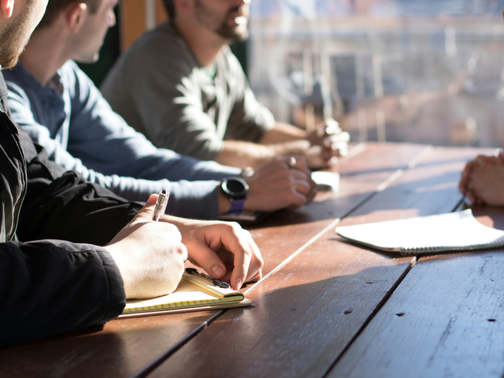 Group of people taking notes